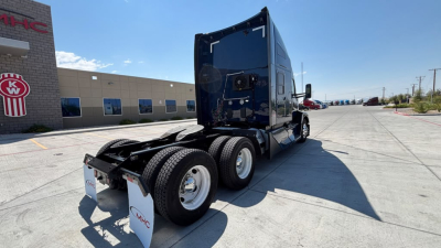 Kenworth T680 tractor rear/side view showing 3-axle setup with dual rear wheels and sleeper cab, no visible text on panels.