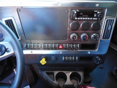 West Star 47X dash panel showing steering wheel, large blank panel, radio, climate controls, and cup holders.