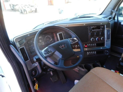 Interior of a new Western Star 47X cab showing steering wheel, instrument cluster, dashboard controls, and driver seat.