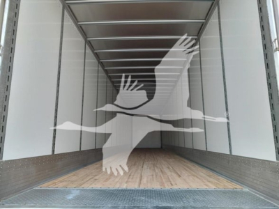 Trailer interior showing empty cargo area with wooden floor and metal side rails inside a Vanguard VXP trailer.