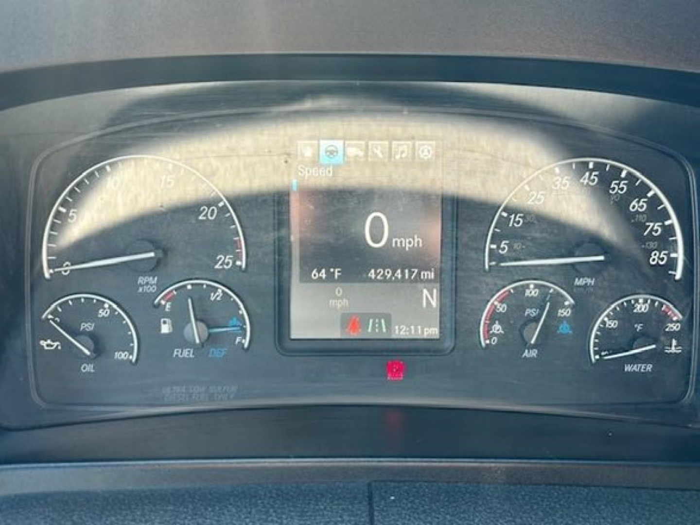 Dashboard of a Freightliner Cascadia 126 showing speedometer, tachometer, fuel gauge, temperature, and digital display with 0 mph and 429.417 miles