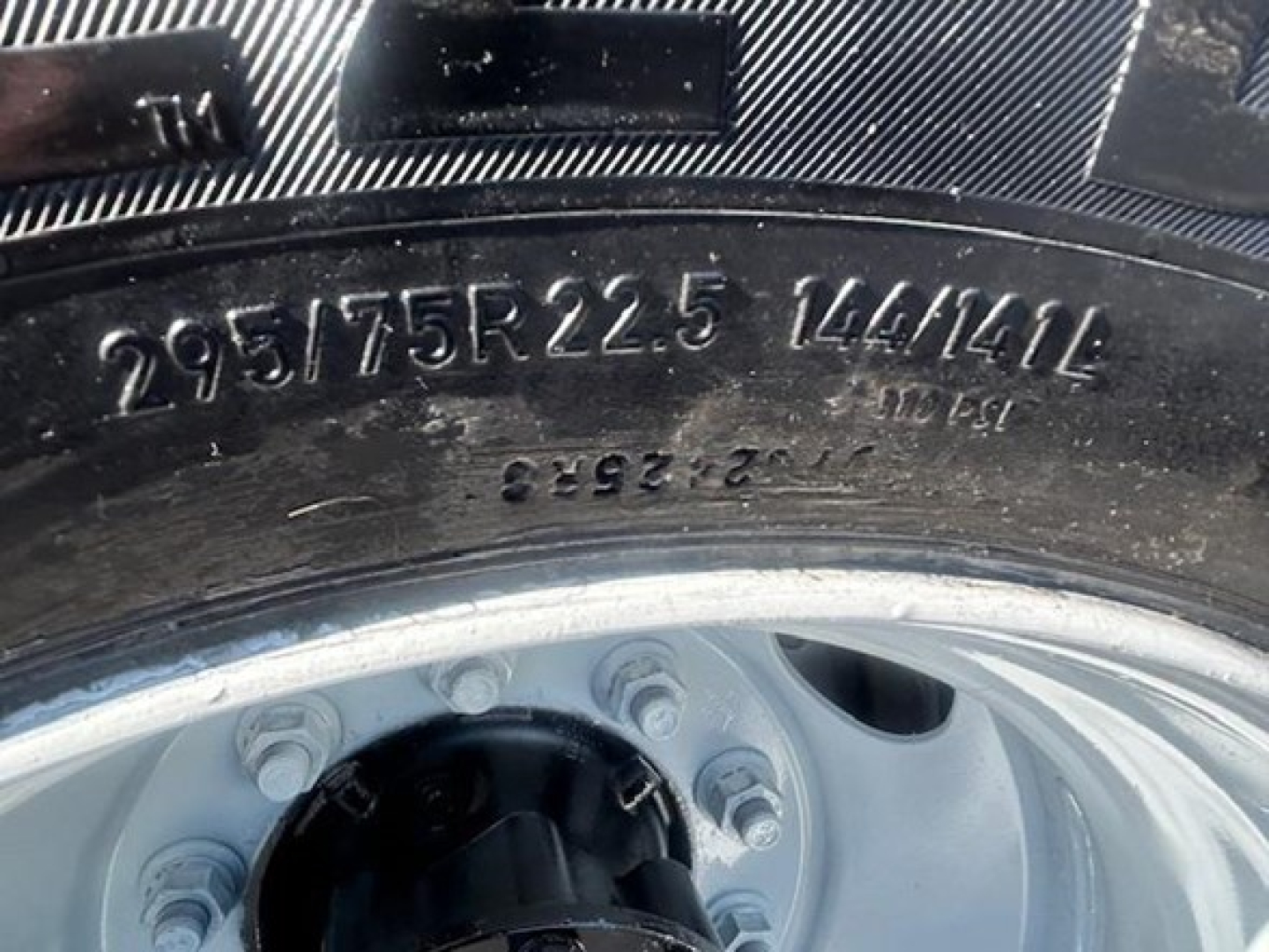 Tire sidewall with markings 295/75R22.5 144/141G on Freightliner Cascadia 126 wheel