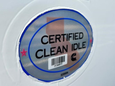 Certified Clean Idle sticker on fuel filler door of a 2023 Freightliner Cascadia 126 truck.