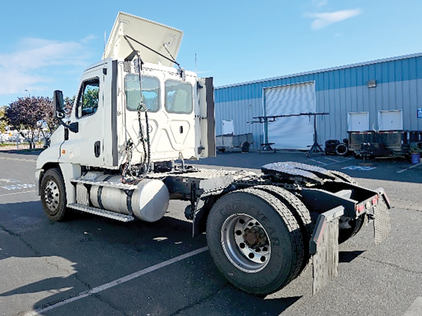 2019 Freightliner Cascadia125 tractor truck chassis side view showing cab with exposed engine bay and dual rear wheels.