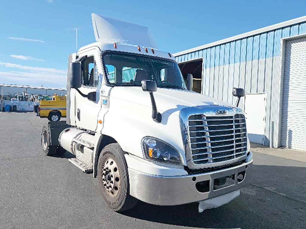 Truck engine bay image of a Freightliner Cascadia125 daycab showing front grille, headlights, and cab; white exterior.