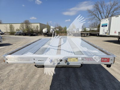 Dropdeck trailer showing rear view of a 2019 Reitnouer Dropmiser 53 trailer with aluminum deck and latching tail. Visible serial/plate area and reflective stickers.