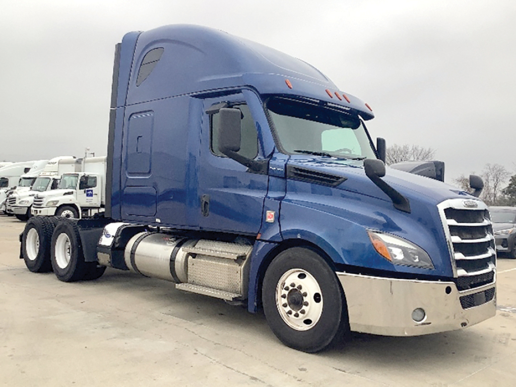 Truck cab side view showing Freightliner Cascadia 126 sleeper with blue paint, chrome bumper, fuel tanks, and dual rear axles.