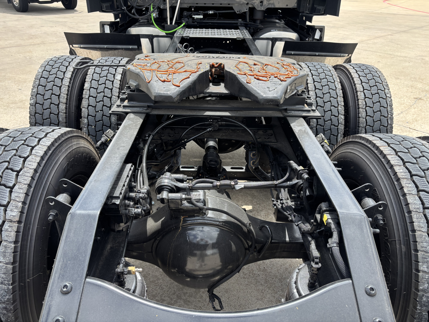 Mack PR64T76H tractor rear suspension and driveline showing rear axles and differential with twin rear wheels.