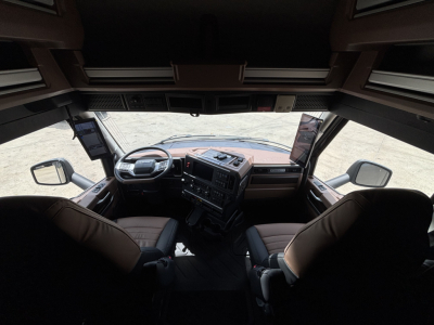 Truck cab interior of a 2027 Mack PR64T76H showing steering wheel, dashboard, and seats.