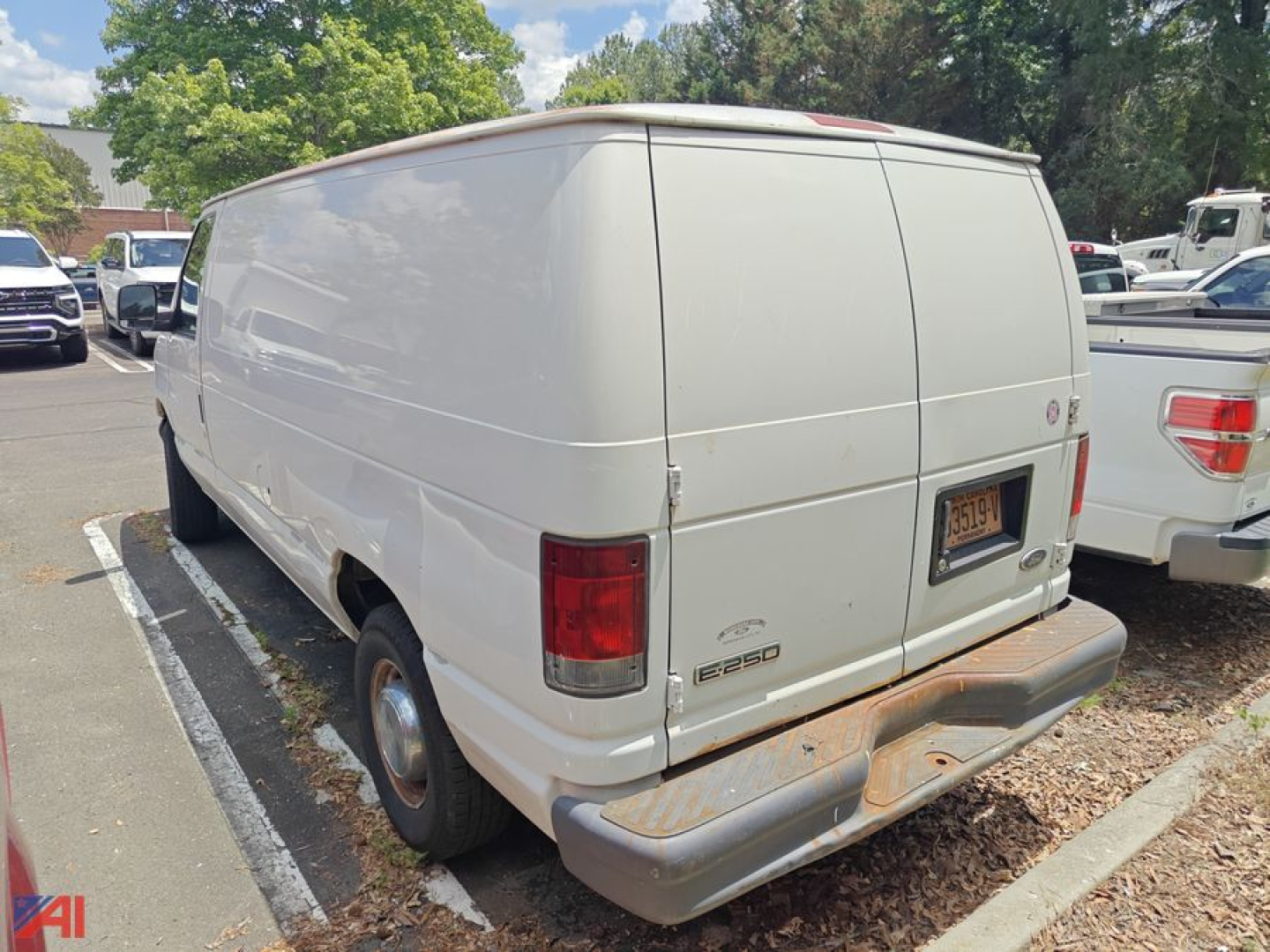 Rear view of a white 2006 Ford E-250 cargo van showing back doors, taillights, and a rust-free bumper with a license plate.