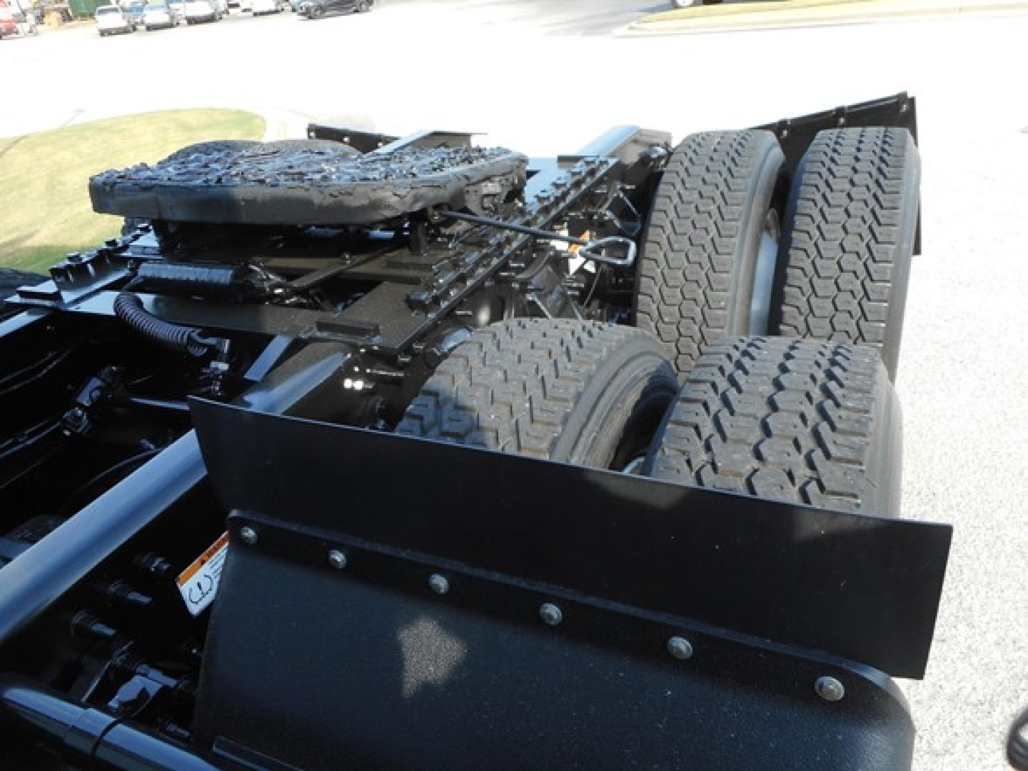 Freightliner Cascadia chassis showing rear dual axles and suspension components.