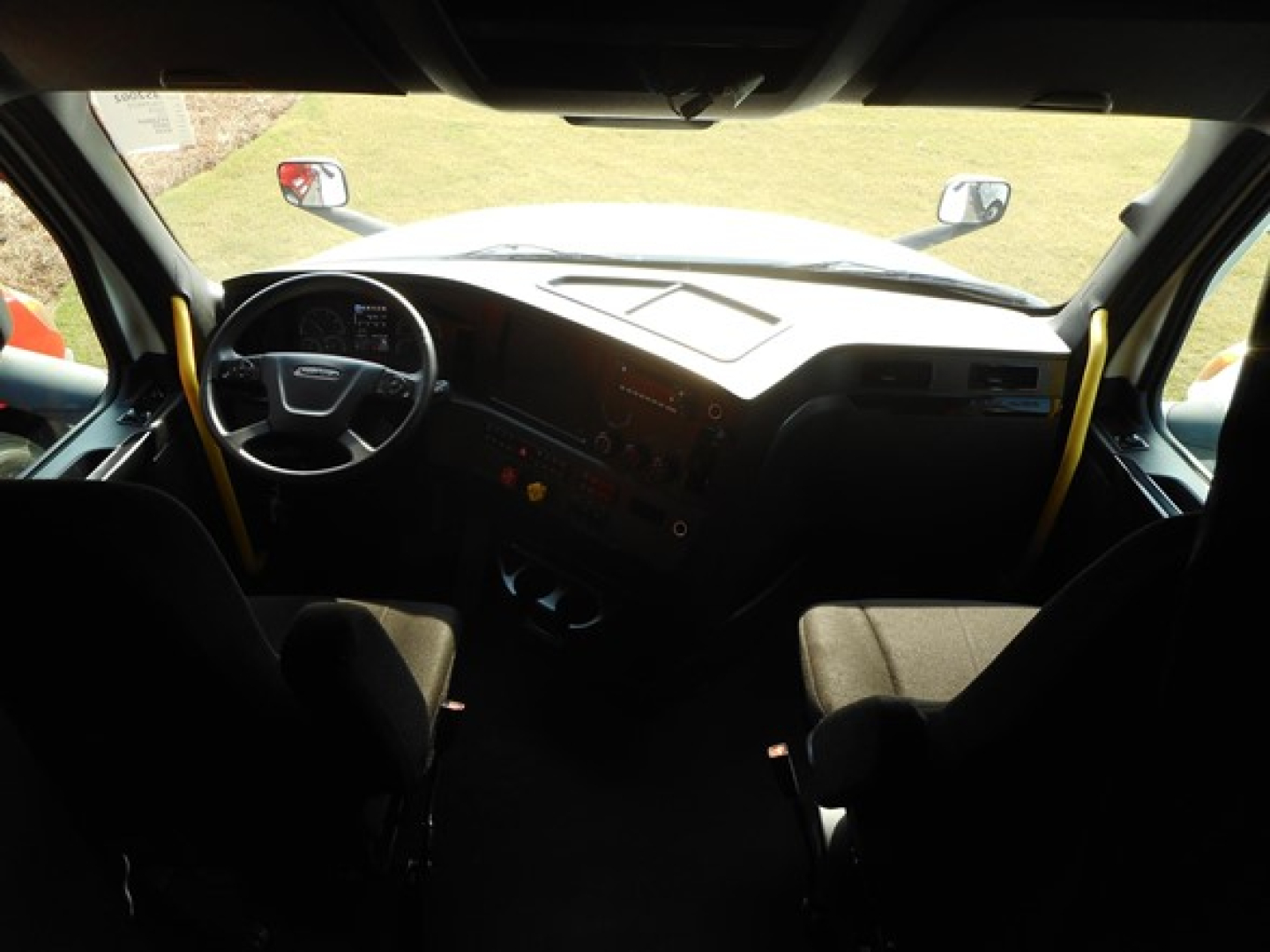Freightliner Cascadia truck interior dashboard and steering wheel viewed from the cabin