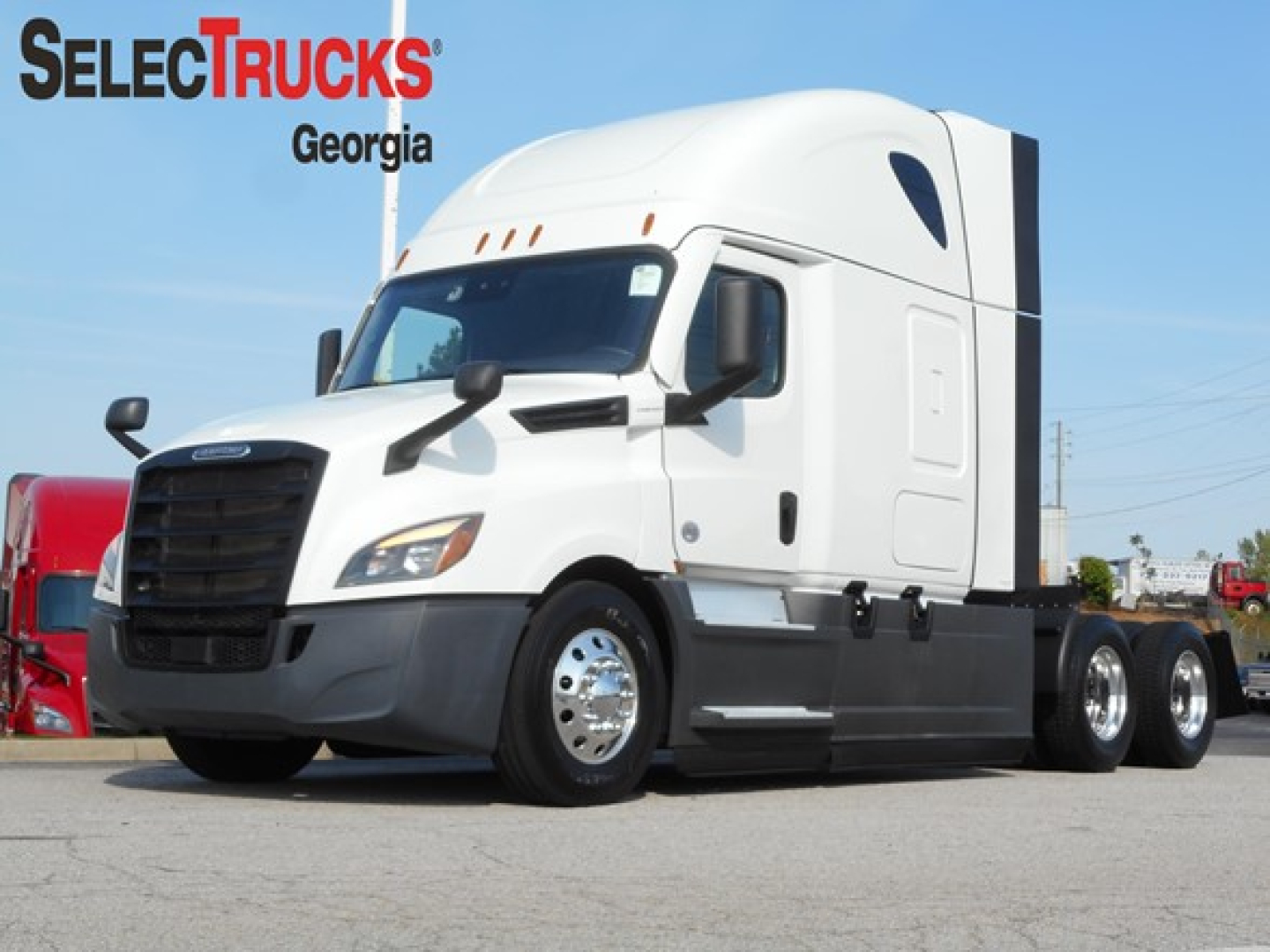 Freightliner Cascadia 126 tractor in white with black lower panels, side view showing sleeper cab and triple rear axles