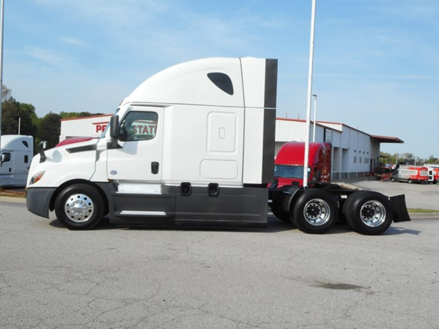 Freightliner Cascadia 126 tractor in side view showing sleeper cab, front fender, dual rear axles, and chrome wheels.