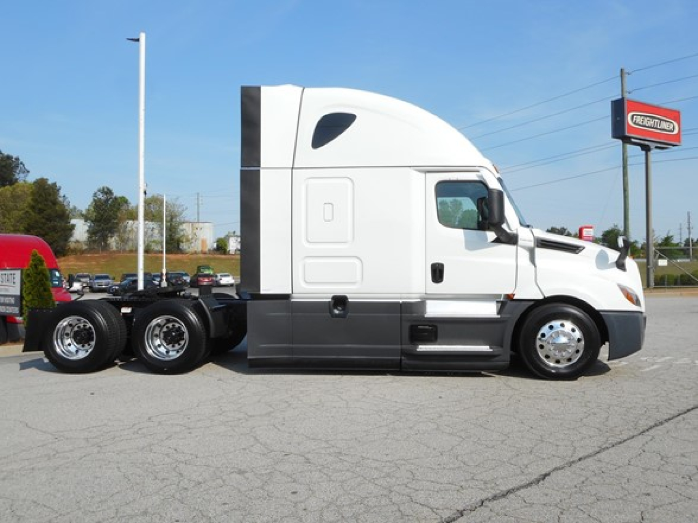 Freightliner Cascadia 126 tractor cab side view showing sleeper, fuel tanks, and dual rear axles.