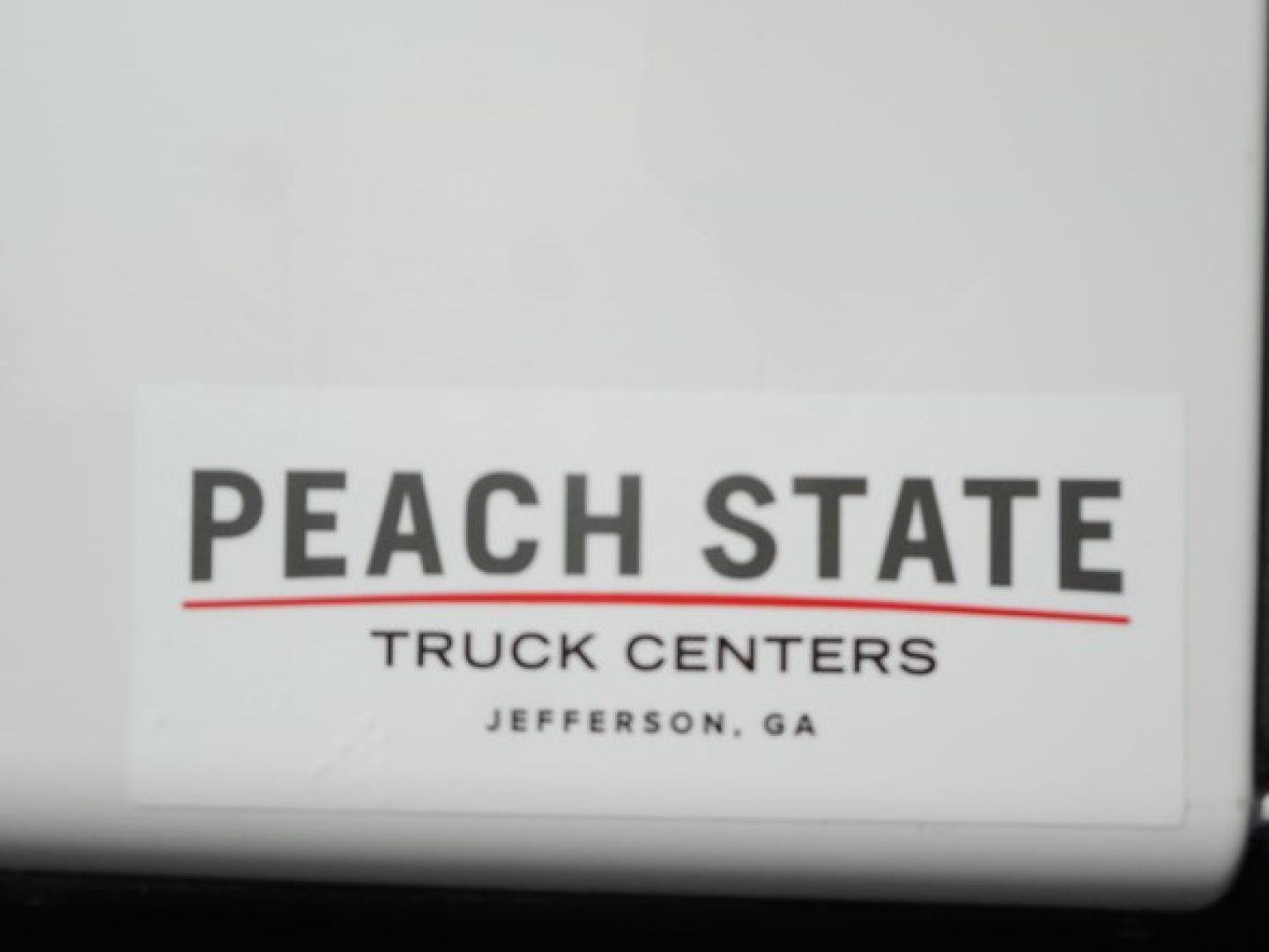 Peach State Truck Centers sticker on white surface.