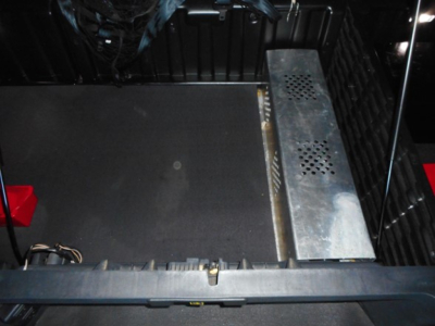 Freightliner Cascadia 126 engine bay showing metal step/guard and various components