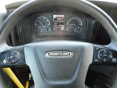 Dashboard view of a Freightliner Cascadia 126 steering wheel with instrument cluster visible and control buttons on both sides.
