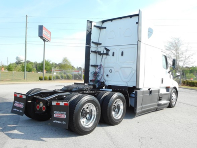 Truck rear three-quarter view of a Freightliner Cascadia 126 tractor showing dual rear axles and fifth wheel area.