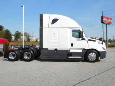 Freightliner Cascadia 126 tractor cab side view showing sleeper, fuel tanks, and dual rear axles.