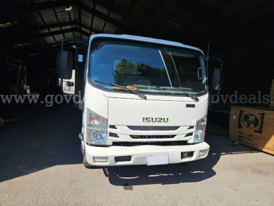 Isuzu NQR truck front view in a warehouse bay showing cab and bumper details.