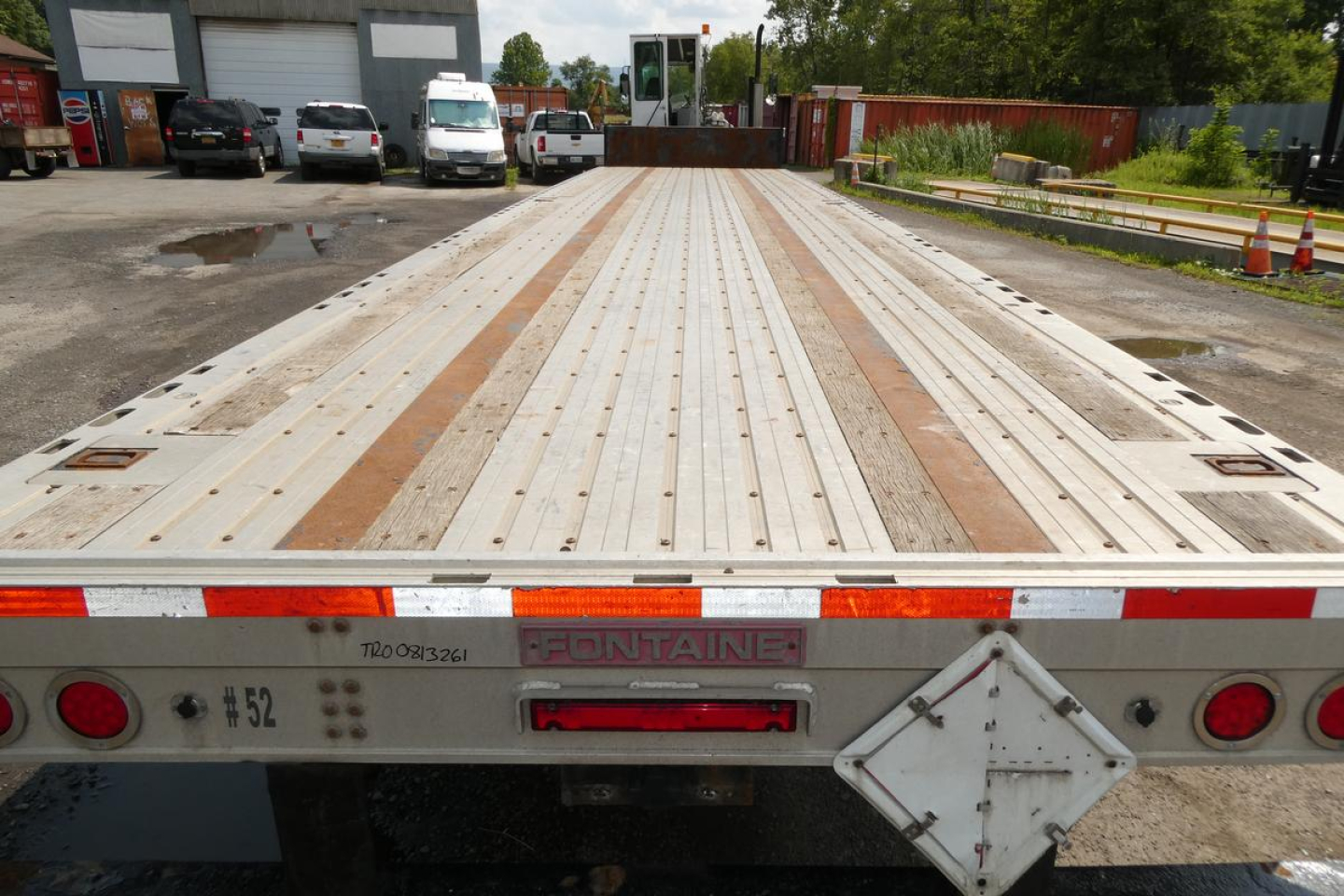 Flatbed trailer bed showing wooden planks and metal decking with taillights and Fontaine branding on rear.