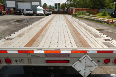 Flatbed trailer bed showing wooden planks and metal decking with taillights and Fontaine branding on rear.