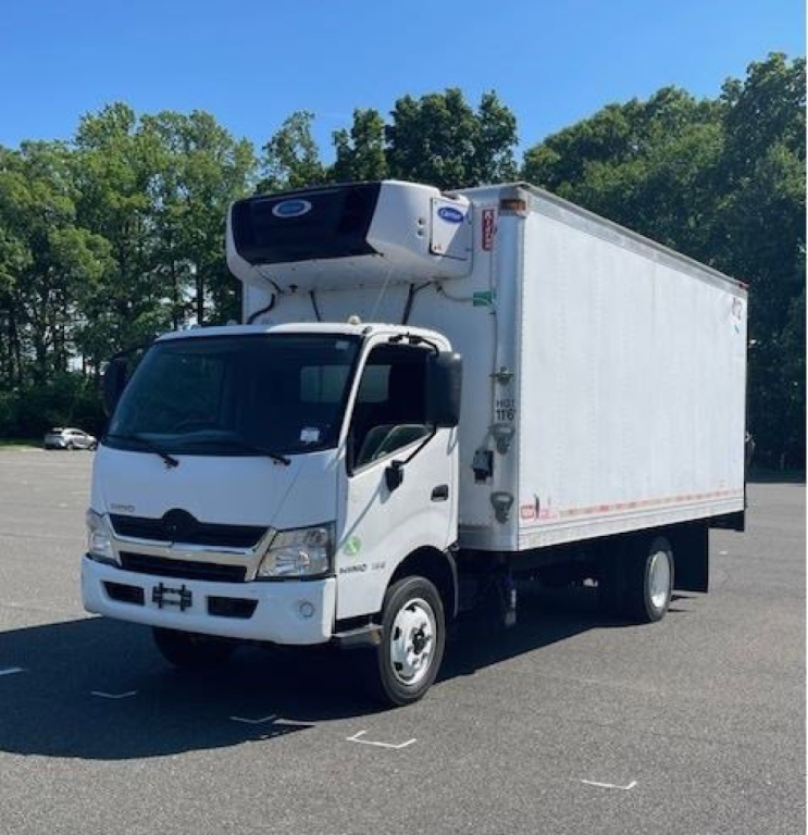 Box van truck showing refrigerated cargo area with Hino cab and front refrigeration unit mounted on the box top.