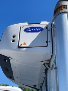 Carrier reefer unit on truck side view showing Carrier logo and panel.