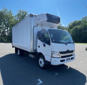 Box truck with a white cab and a refrigerated box, cooling unit mounted on the front of the box roof. Side mirrors, headlights, and logo visible on cab.