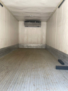 Truck cargo area of a 2020 Hino 195 box van showing empty aluminum interior with ribbed floor and rear overhead vent.