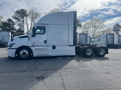 Freightliner Cascadia 126 truck side view showing aerodynamic cab with sleeper, white color, dual rear axles, and same. Visible text: none readable on image.