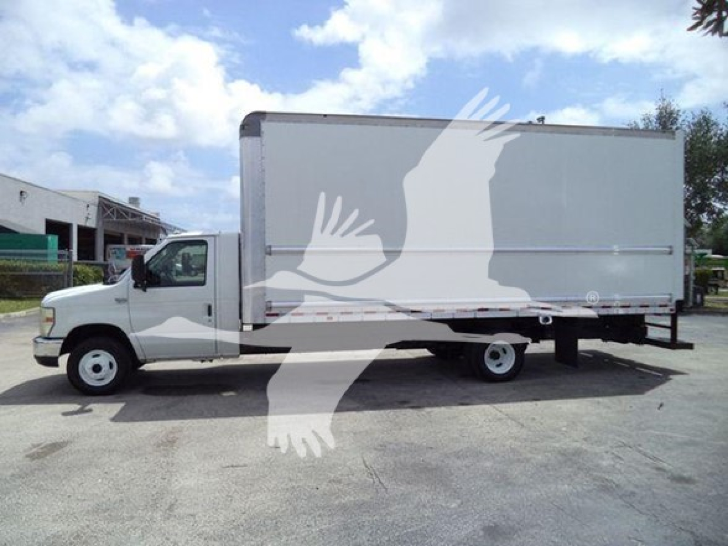 2011 Ford E450 box truck with large cargo box, side view showing cab and box. Vehicle appears used; no visible text on cab or box 