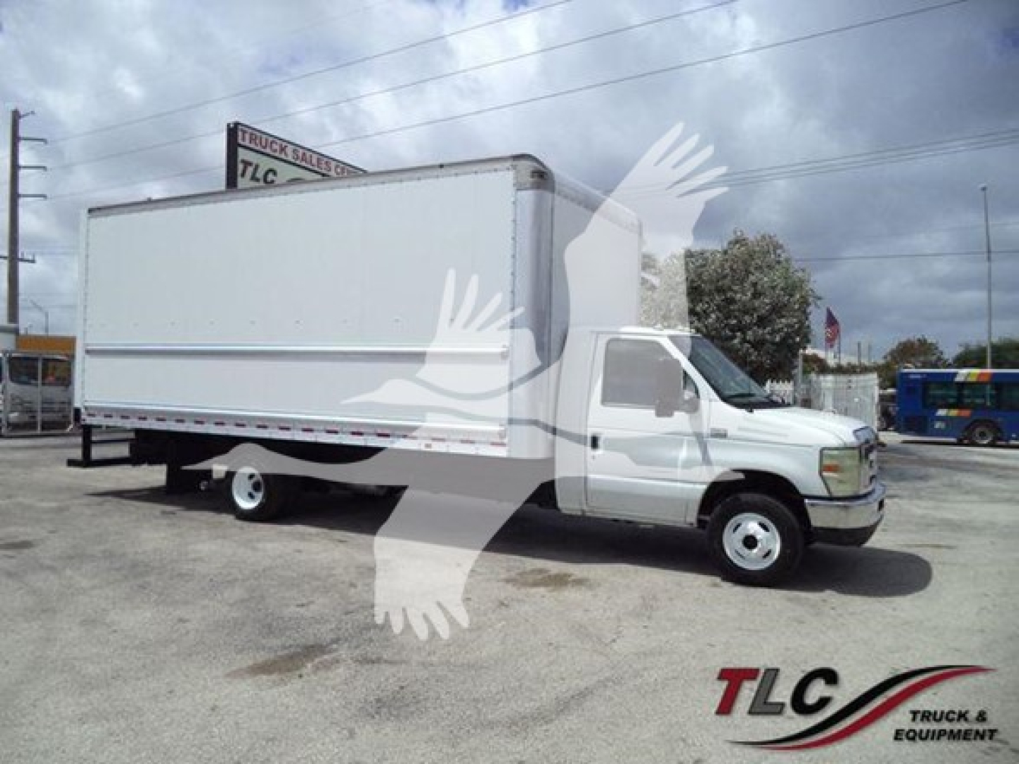 Ford E450 box truck with white cargo box and cab, side view, no visible text on box, parking lot background.