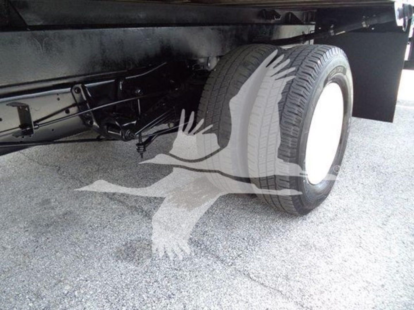 Ford E-450 chassis showing rear wheel and suspension components under box truck.