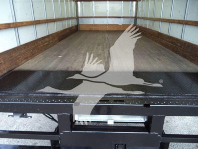 Ford E-450 truck bed area showing empty truck cargo space and rear floor; no visible text on components.