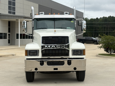 Front view of a white 2027 Mack PI64T conventional daycab truck showing large grille, bumper, and vertical exhaust stacks.