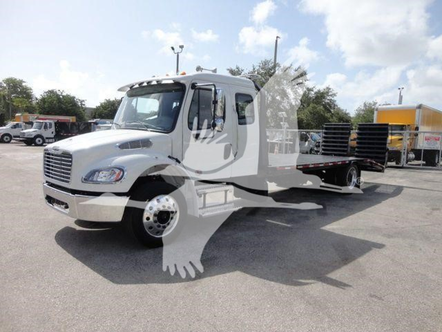 2027 Freightliner Business Class M2 rollback truck with flatbed car carrier in lot. Title overlay shows a truck, stock number notations not legible.