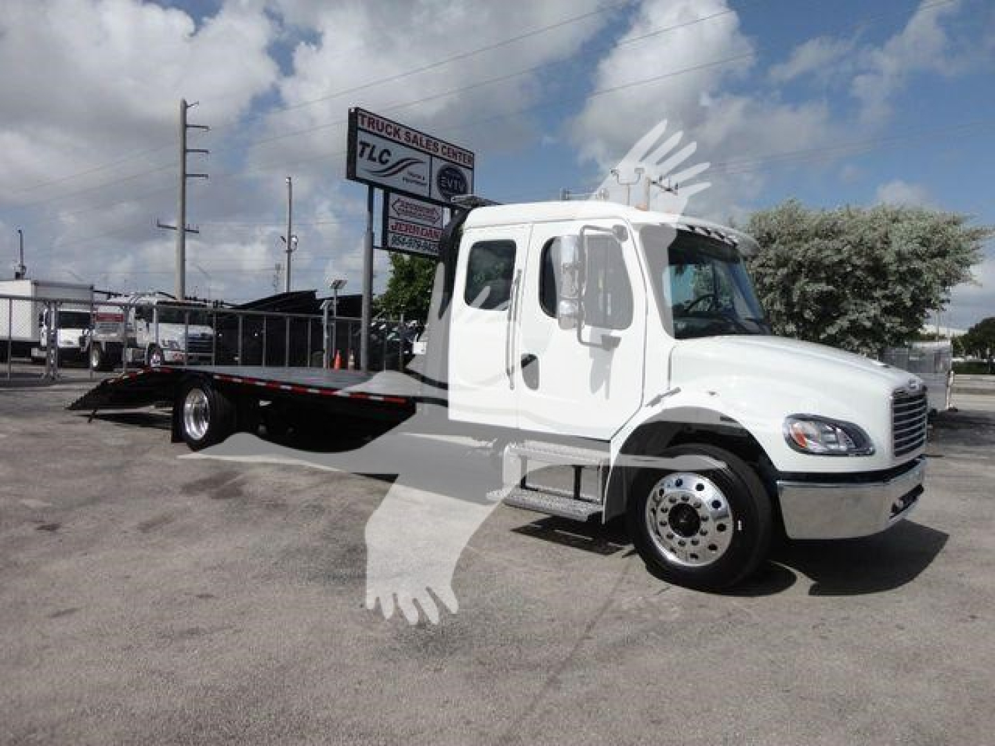 Freightliner Business Class M2 rollback truck shown in side profile with flatbed extendable rollback bed.