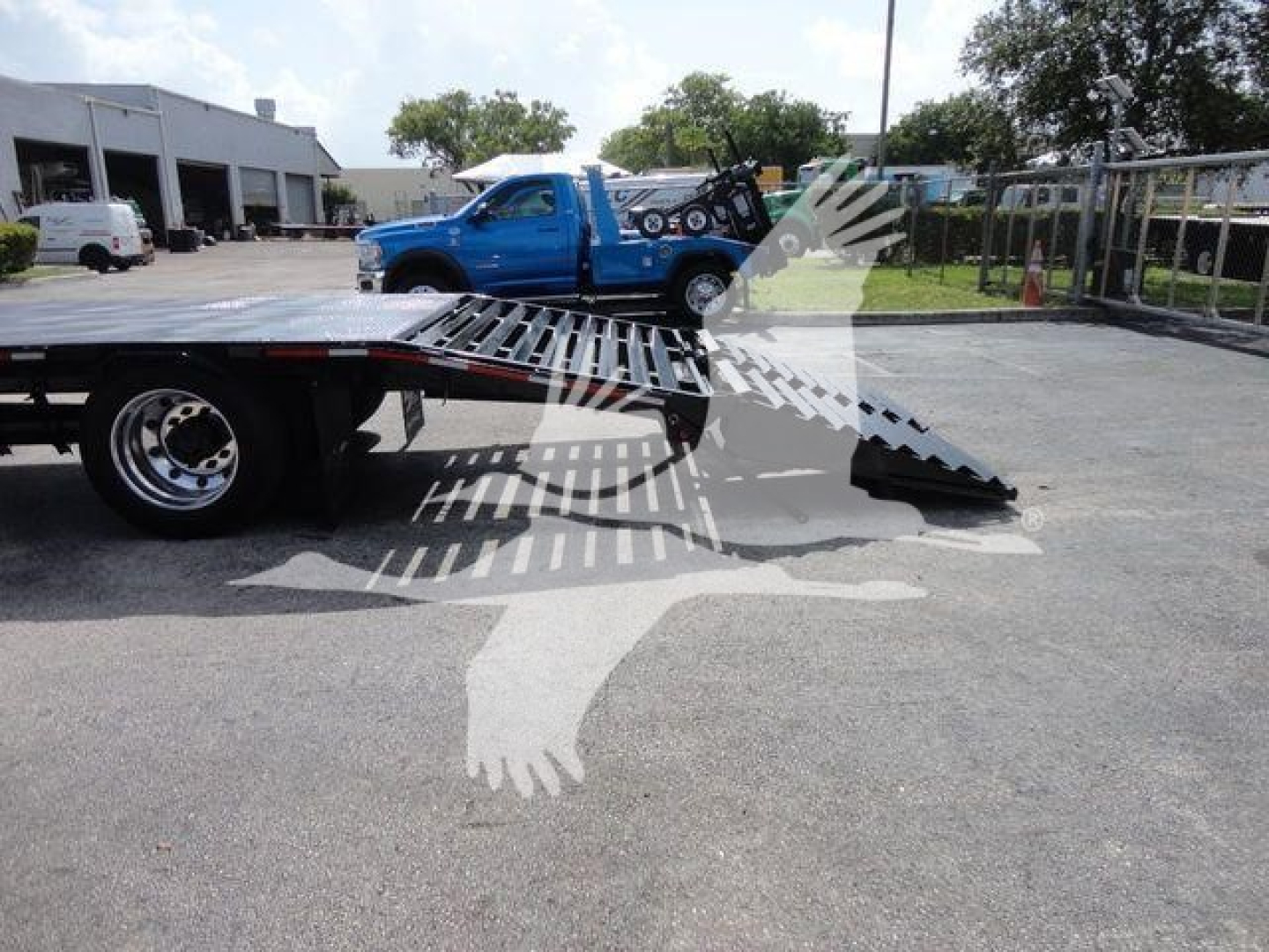 Freightliner Business Class M2 rollback truck bed with wheel lift and low-angle view showing loading ramps.