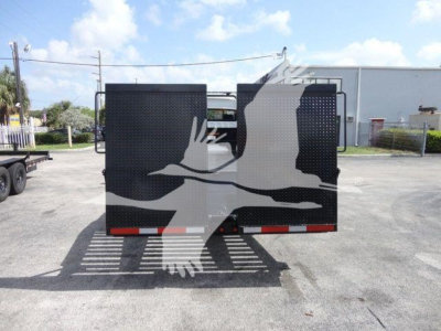Back view of a Freightliner Business Class M2 rollback truck trailer with black rear doors and reflective tape.