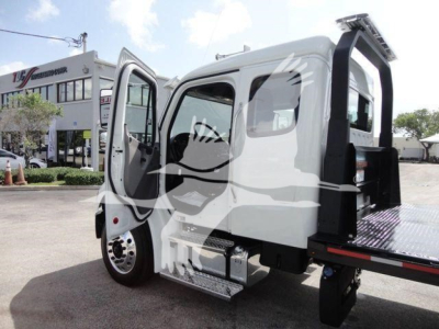 Freightliner Business Class M2 rollback truck with open door and flatbed section, side view showing cab and entry steps.