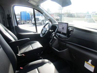 Ford Transit cargo van interior showing steering wheel, touchscreen display, and front seats.