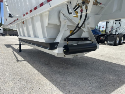 Dump trailer underside view showing hydraulic lift, black hydraulic cylinder, and support frame with white painted metal; part of CTS BDT-40 model.