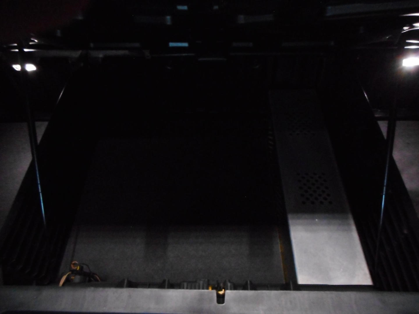 Truck cabin interior cargo area showing metal flooring and side access; no legible text or labels visible.