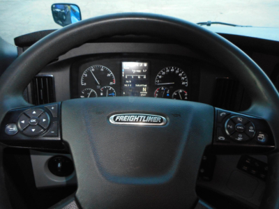 Freightliner Cascadia 126 dashboard and steering wheel showing instrument cluster and steering wheel controls.