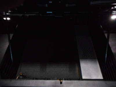 Truck cabin interior cargo area showing metal flooring and side access; no legible text or labels visible.