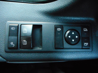 Freightliner Cascadia control panel with window switches, mirror adjust, and lock buttons.