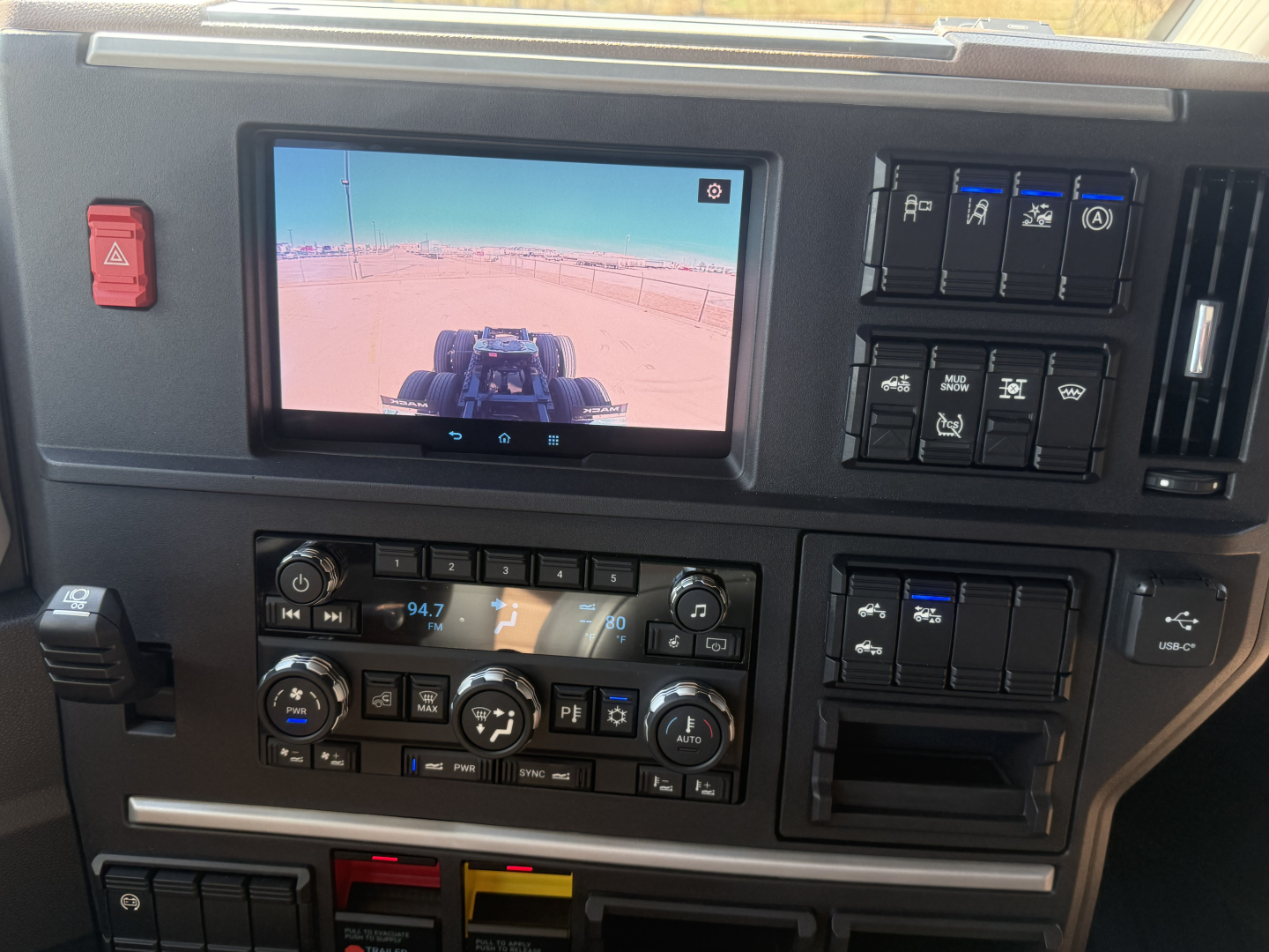 Cab interior of a 2026 Mack PR64T76H showing dashboard with touchscreen display and climate control panel.