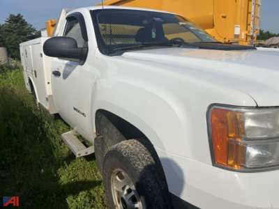 GMC Sierra 2500HD utility truck in white with extended cab, side steps, utility chest on bed, front right angle view.